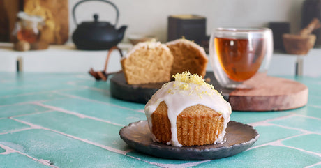 Cupcakes made with black tea on a turquoise tile counter and a kitchen background